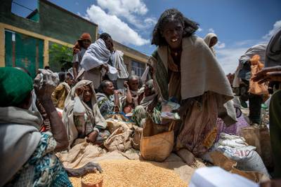 An Ethiopian woman leaves with a portion of yellow split peas after it was distributed by the Relief Society of Tigray in the town of Agula, in the Tigray region of northern Ethiopia. AP Photo