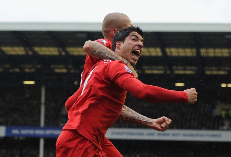 LIVERPOOL, ENGLAND - OCTOBER 28:  Luis Suarez of Liverpool celebrates scoring his team's second goal with team mate Martin Skrtel (L)  during the Barclays Premier League match between Everton and Liverpool at Goodison Park on October 28, 2012 in Liverpool, England.  (Photo by Chris Brunskill/Getty Images) *** Local Caption ***  154873417.jpg