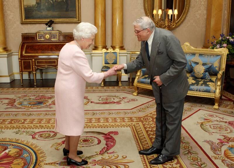 Queen Elizabeth presents artist David Hockney with the Order of Merit at Buckingham Palace. Getty