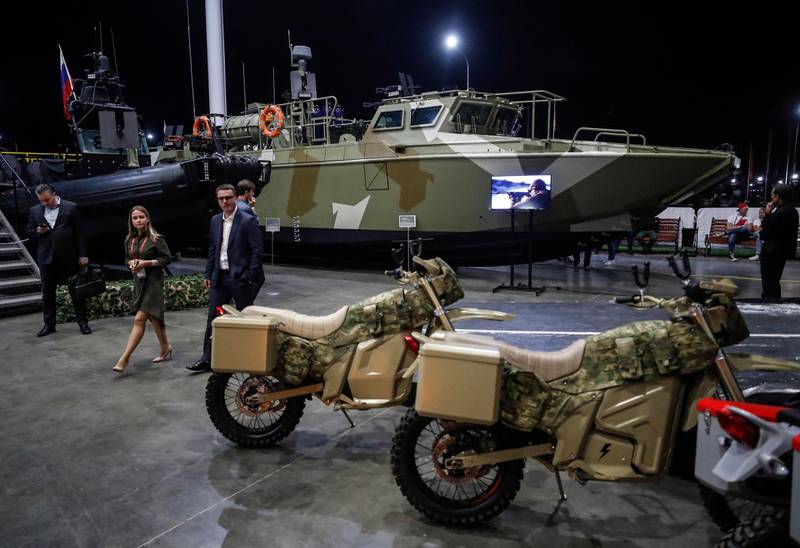 epa06961006 Visitors examine products of JSC 'Concern Kalashnikov' prior the International Military Technical Forum 'Army 2018' in Patriot Park in Alabino, Moscow region, Russia, late 20 August 2018. Kalashnikov, part of the state Corporation 'Rostec', is the largest Russian manufacturing company that produces assault and sniper rifles, guided artillery projectiles and a wide range of precision weapons. The Concern contains three brands: 'Kalashnikov'(combat and civilian weapons), 'Baikal' (hunting and civilian guns), and 'Izhmash' (sporting rifles), also the Concern is developing new business - remote weapon stations, unmanned aerial vehicles and multi-functional special-purpose boats.  EPA/SERGEI ILNITSKY