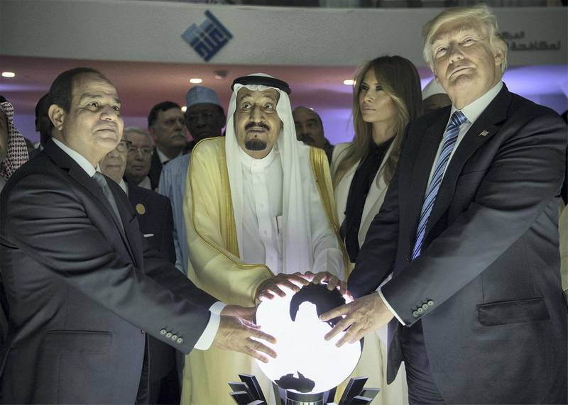 RIYADH, SAUDI ARABIA - MAY 21: (----EDITORIAL USE ONLY  MANDATORY CREDIT - "BANDAR ALGALOUD / SAUDI ROYAL COUNCIL / HANDOUT" - NO MARKETING NO ADVERTISING CAMPAIGNS - DISTRIBUTED AS A SERVICE TO CLIENTS----)US President Donald Trump, US First lady Melania Trump (2nd R), Saudi Arabia's King Salman bin Abdulaziz al-Saud (2nd L) and Egyptian President Abdel Fattah el-Sisi (L) put their hands on an illuminated globe  during the inauguration ceremony of the Global Center for Combating Extremist Ideology in Riyadh, Saudi Arabia on May 21, 2017. (Photo by Bandar Algaloud / Saudi Royal Council / Handout/Anadolu Agency/Getty Images)
