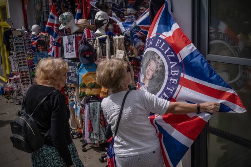 Customers view a souvenir flag commemorating the platinum Jubilee of Queen Elizabeth outside a shop in Windsor. Getty Images