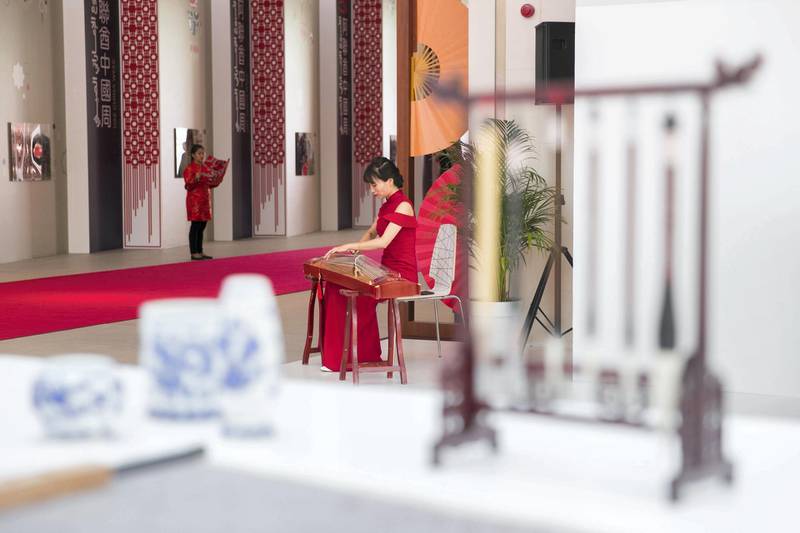 ABU DHABI, UNITED ARAB EMIRATES - JULY 18, 2018. A female plays the gzheng as part of UAE-China Week events at Manarat Al Saadiyat in Abu Dhabi, photos show UAE-China strong relationship over the past years. A pavilion to celebrate the UAE and Chinese culture was set up at the venue and will be the centerpiece of the UAE-China Week that runs until July 24.(Photo by Reem Mohammed/The National)Reporter: Section: NA