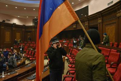 Armenians protest against the country's agreement to end fighting with Azerbaijan over the disputed Nagorno-Karabakh region inside the parliament in Yerevan. AFP