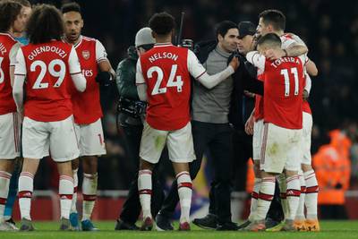 Arsenal manager Mikel Arteta, right, celebrates with his players. AP