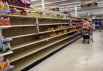 A shopper looks for bread in a partly empty shelf as people prepare before the possible arrival of Hurricane Sally in Bayou La Batre, Alabama. AFP