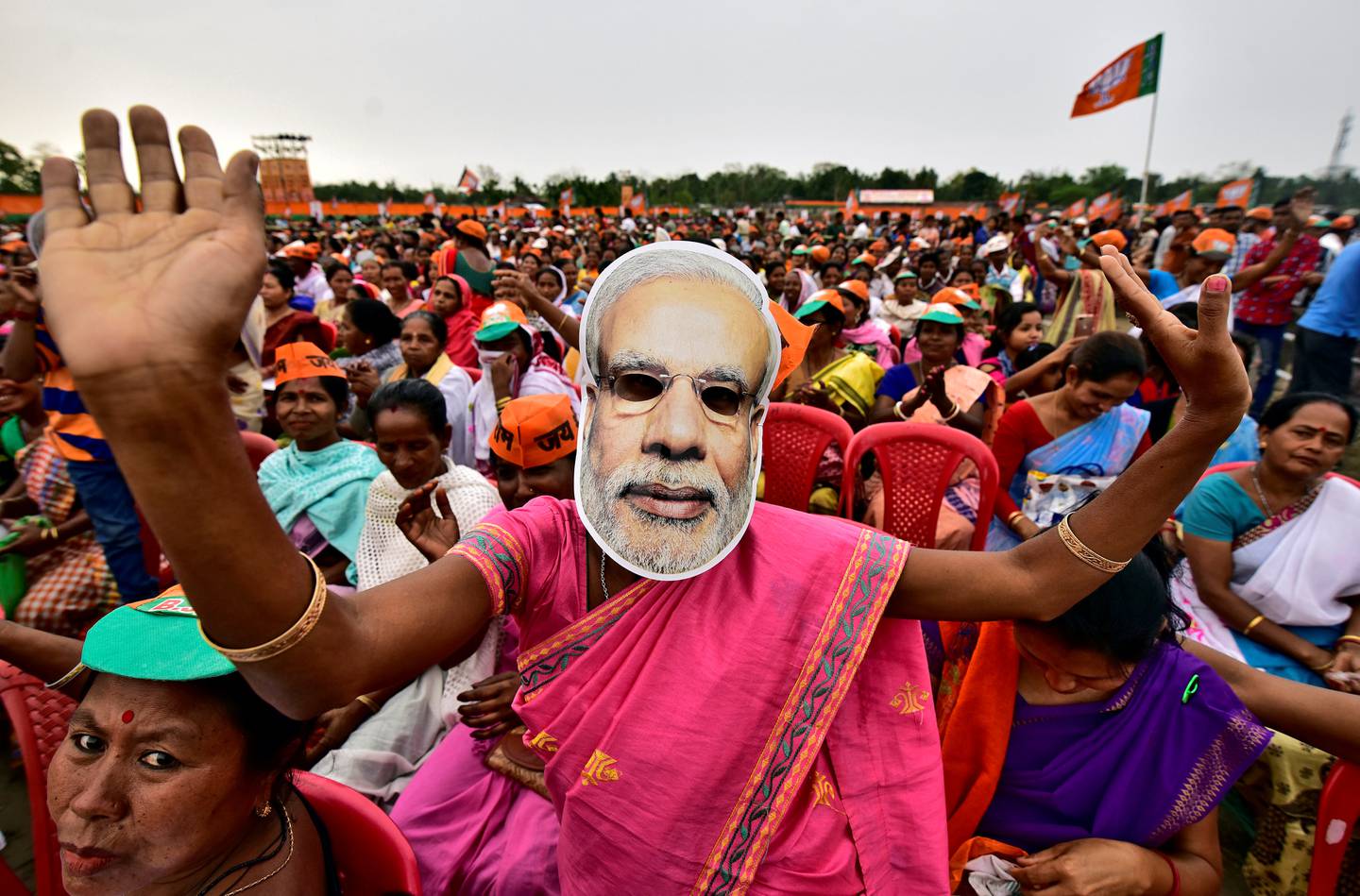 FILE PHOTO: A woman wearing a mask of Prime Minister Narendra Modi dances as she attends an election campaign rally being addressed by India's ruling Bharatiya Janata Party (BJP) President Amit Shah at Ahatguri village in Morigaon district in the northeastern state of Assam, India, April 5, 2019. REUTERS/Anuwar Hazarika/File Photo