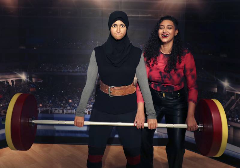 Amna Al Haddad, UAE weightlifting champion, poses with her wax statue at the opening of Madame Tussauds museum in Dubai. AP