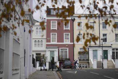 A pedestrian walks past residential houses in the Notting Hill district of London, U.K., on Tuesday, Nov. 24, 2020. Asking prices for U.K. homes slipped this month as owners sought to get sales agreed in time to benefit from a temporary tax cut. Photographer: Simon Dawson/Bloomberg Photographer: Simon Dawson/Bloomberg