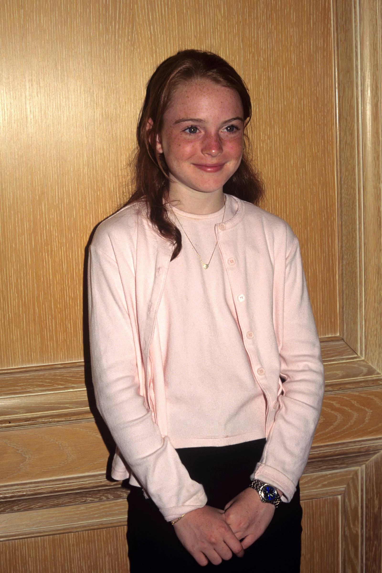 Lindsay Lohan, in a light pink top and cardigan, attends a Los Angeles press conference in January 1999. PA