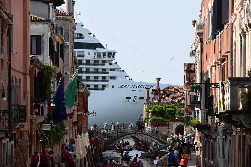 - AFP PICTURES OF THE YEAR 2019 - 

MSC Magnifica is seen from one of the canals leading into the Venice Lagoon on June 9, 2019 in Venice.
  Thousands of people took to the streets in Venice on June 8, 2019, calling for a ban on large cruise ships in the city following last week's collision between a massive vessel and a tourist boat.  - 
 / AFP / Miguel MEDINA
