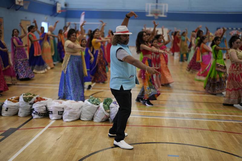 Dance captain and choreographer Jay Kumar goes through the dance moves with performers.