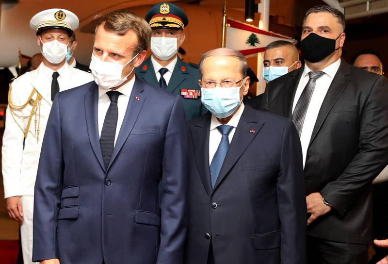 TOPSHOT - A handout picture provided by the Lebanese photo agency Dalati and Nohra on August 31, 2020 shows Lebanese President Michel Aoun (C-R) and French President Emmanuel Macron (C-L), both wearing face masks due to the Covid-19 pandemic, during a welcome ceremony at Beirut International airport. Macron arrived in Beirut for his second visit since a deadly explosion on August 4 shook the nation and fuelled a drive for political change. Macron, who first flew to Beirut only two days after the blast, arrived at 9 pm (1800 GMT) for a two-day visit that will include a ceremony marking the centenary of Greater Lebanon. - === RESTRICTED TO EDITORIAL USE - MANDATORY CREDIT "AFP PHOTO / HO / DALATI AND NOHRA" - NO MARKETING - NO ADVERTISING CAMPAIGNS - DISTRIBUTED AS A SERVICE TO CLIENTS ===
 / AFP / DALATI AND NOHRA / - / === RESTRICTED TO EDITORIAL USE - MANDATORY CREDIT "AFP PHOTO / HO / DALATI AND NOHRA" - NO MARKETING - NO ADVERTISING CAMPAIGNS - DISTRIBUTED AS A SERVICE TO CLIENTS ===
