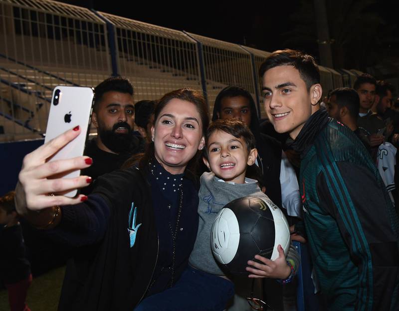 Paulo Dybala of Juventus signing autographs and taking selfies. Getty