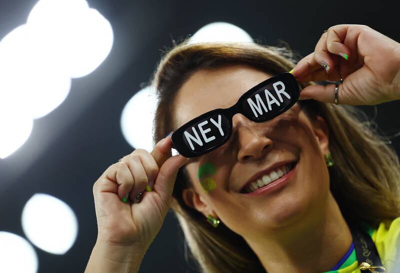 A Brazil fan with star player Neymar written on their sunglasses. Reuters