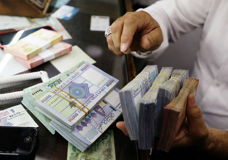 A man counts Lebanese pounds at a currency exchange shop in Beirut, Lebanon October 1, 2020. Picture taken October 1, 2020. REUTERS/Mohamed Azakir