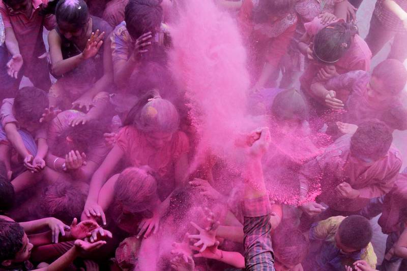 A teacher throws coloured powder on schoolchildren during celebrations marking Holi at a school in Ahmadabad on March 5. Ajit Solanki / AP Photo