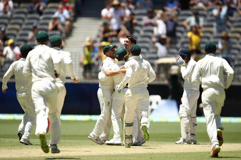 PERTH, AUSTRALIA - DECEMBER 18: Pat Cummins of Australia celebrates with team mates after taking a catch off his own bowling to dismiss Jasprit Bumrah of India and claim victory during day five of the second match in the Test series between Australia and India at Perth Stadium on December 18, 2018 in Perth, Australia. (Photo by Ryan Pierse/Getty Images)