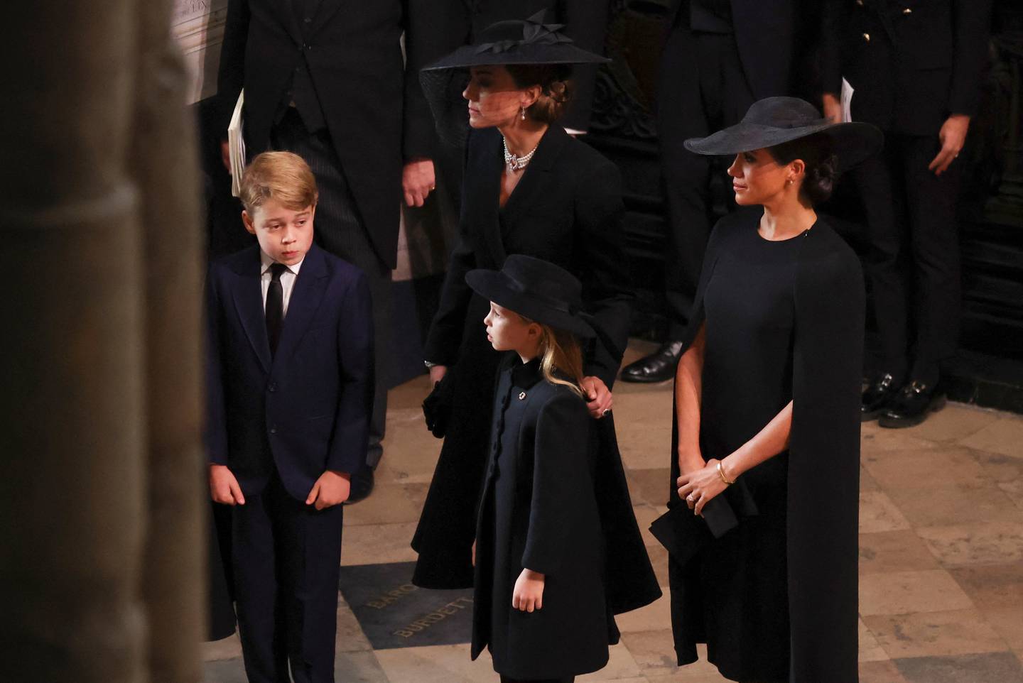 Prince George, Princess Charlotte, the Princess of Wales, and the Duchess of Sussex stand together during the funeral of Queen Elizabeth II. PA News