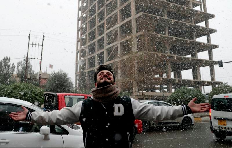A man walks in the snow in Erbil, Iraq. AP Photo