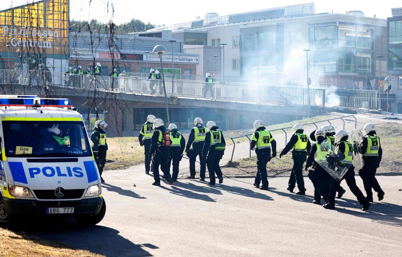Riot police prepare to enter a shopping centre during protests in Norrkoping. AFP