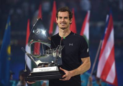 Andy Murray poses with the trophy after winning the Dubai Duty Free Tennis Championships title. Tom Dulat / Getty Images