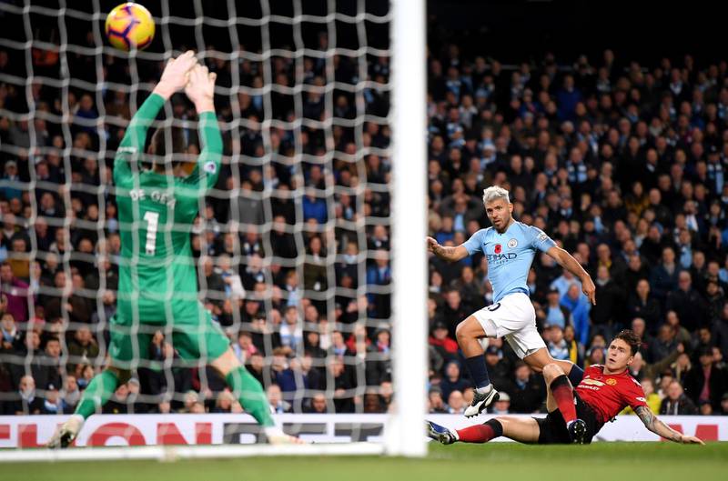 MANCHESTER, ENGLAND - NOVEMBER 11:  Sergio Aguero of Manchester City scores his team's second goal past David De Gea of Manchester United while being challenged by Victor Lindelof of Manchester United during the Premier League match between Manchester City and Manchester United at Etihad Stadium on November 11, 2018 in Manchester, United Kingdom.  (Photo by Laurence Griffiths/Getty Images)