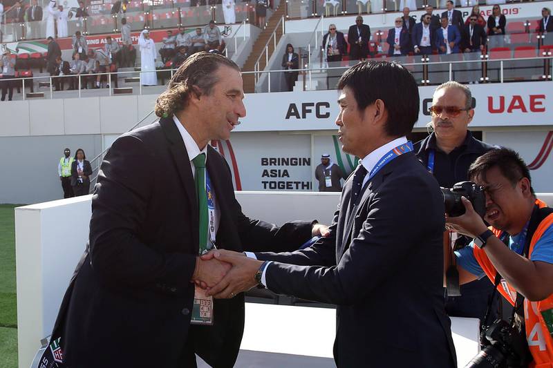 Japan's head coach Hajime Moriyasu, right, and Saudi Arabia's head coach Juan Antonio Pizzi shake hands prior to the Asian Cup last-16 match in Sharjah. EPA