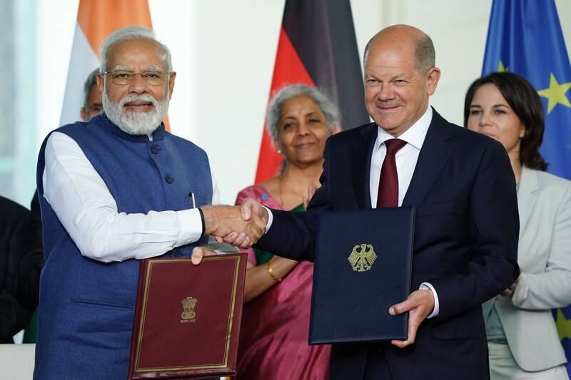 German Chancellor Olaf Scholz, right, and Indian Prime Minister Narendra Modi shake hands after signing a set of agreements to deepen India's ties with Germany, at the Chancellery in Berlin, on Monday. Getty Images