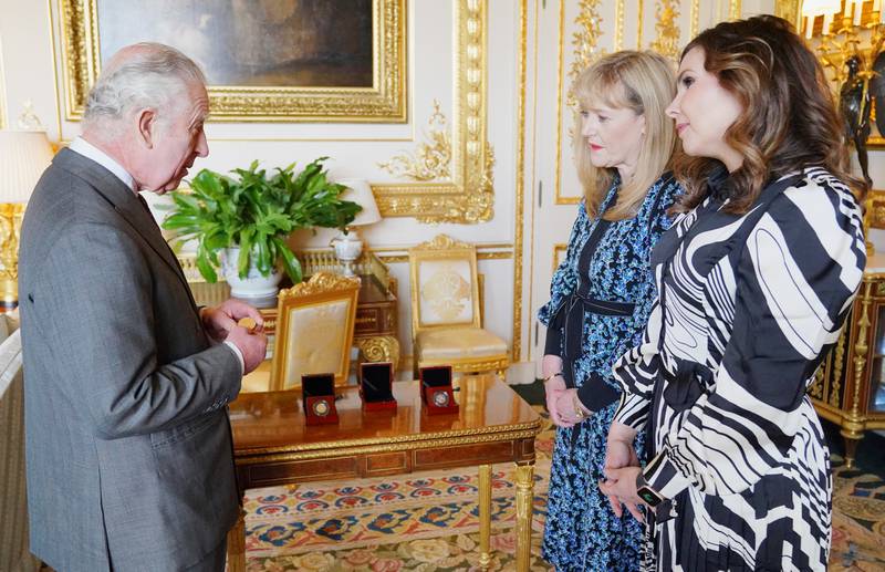 King Charles is presented with the first struck £5 coronation coin by Royal Mint chief executive Anne Jessopp and director Rebecca Morgan at Windsor Castle. Reuters
