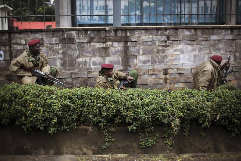 Kenyan troops use a wall as cover in the firefight with Al Shabab. AFP