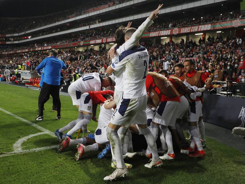 Serbia's Aleksandar Mitrovic celebrates scoring their second goal with teammates. Reuters