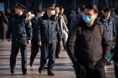 A security officer wears a face mask as he patrols outside of the Beijing Railway Station in Beijing, Monday, Jan. 20, 2020. AP Photo / Mark Schiefelbein