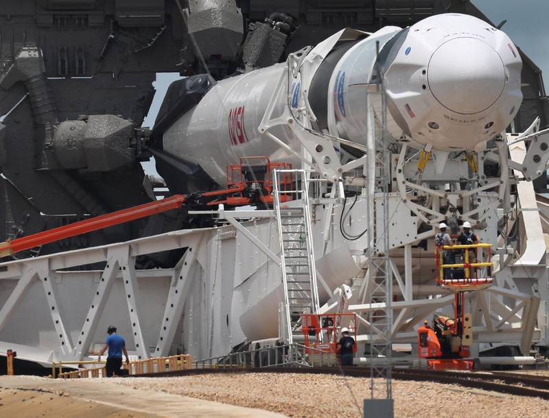 Workers prepare the SpaceX Falcon 9 rocket. AFP
