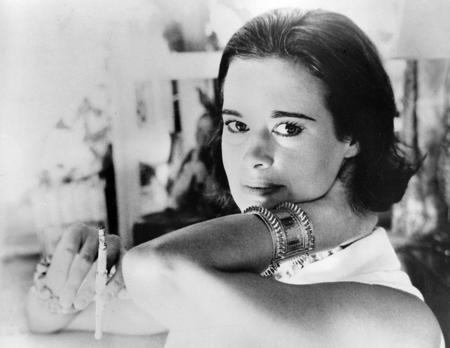 FILE - In this Jan. 4, 1964 file photo, railroad heiress Gloria Vanderbilt poses for a photograph. Vanderbilt, the intrepid heiress, artist and romantic who began her extraordinary life as the "poor little rich girl" of the Great Depression, survived family tragedy and multiple marriages and reigned during the 1970s and '80s as a designer jeans pioneer, died Monday, June 17, 2019,  at the age of 95.  (AP Photo, File)