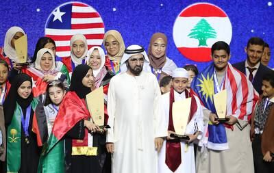 Sheikh Mohammed bin Rashid congratulates the UAE's Amnah Al Mansoori and Qatar's Abdullah Al Berri on being named Arab Reading Challenge champions. Pawan Singh / The National