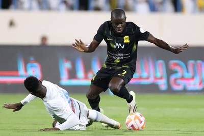 Al Ittihad's N'Golo Kante takes the ball past Al Okhdood defender Saeed Alrubaei. AFP