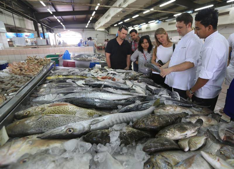 Guests go the fish market with chefs from Market Kitchen to learn how to select fish. Ravindranath K / The National