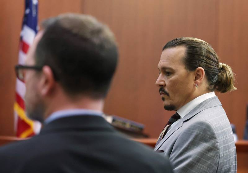Depp returns from a break and stands for the jury. AFP