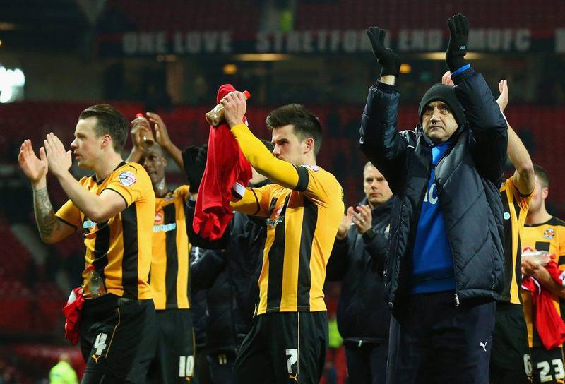 Cambridge United manager Richard Money and his players applaud fans after their defeat to Manchester United in their FA Cup fourth round replay at Old Trafford. Alex Livesey / Getty Images  