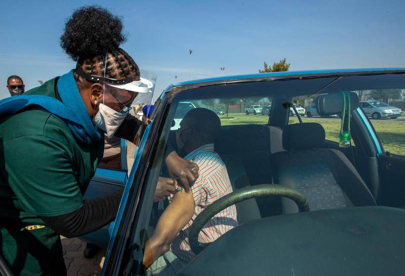 A health worker vaccinates a pensioner with a first dose of the Pfizer Covid-19 shot in Johannesburg, South Africa. AP