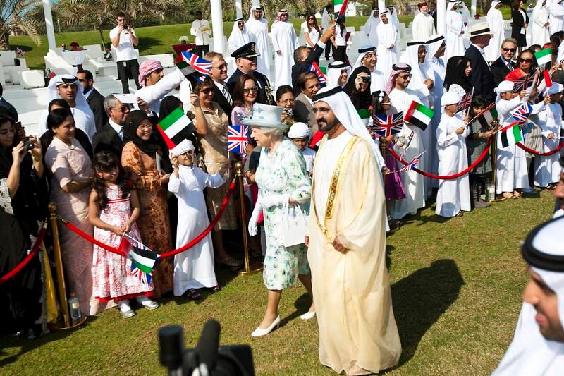 Sheikh Mohammed bin Rashid, Vice President and Ruler of Dubai, and Queen Elizabeth greet spectators at Emirates Palace in Abu Dhabi in November 2010. Andrew Henderson/The National