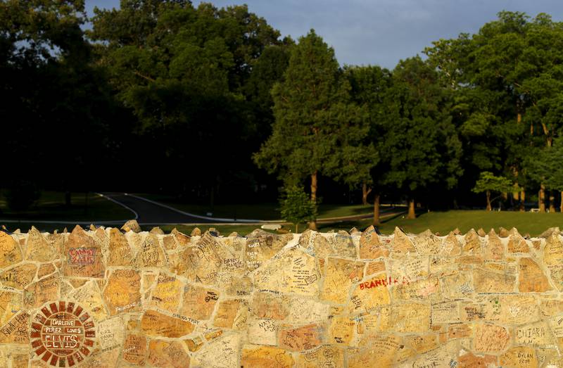 Messages from fans from all over the world cover the rock wall surrounding Graceland. Reuters