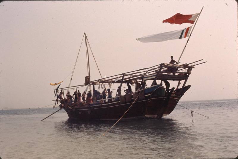 The dhow and crew, including divers, in the Arabian Gulf. 