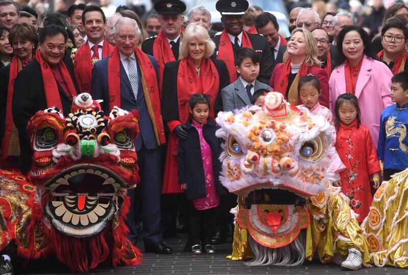 Britain's Prince Charles and Camila, Duchess of Cornwall, pose with dragons as they visit the Chinatown district of London, Britain, 01 February 2022.  The royal couple spoke with members of the Chinese community to celebrate the Lunar New Year that falls on 01 February 2022 and marks the 'Year of the Tiger,' one of the 12 animals of the Chinese Zodiac. EPA