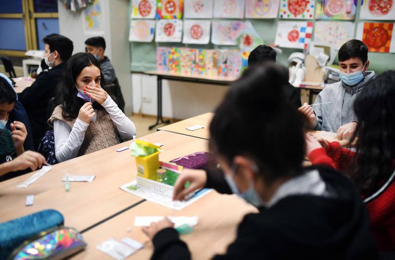 Pupils take a sample for a rapid test during the first lesson after Christmas holidays at the Freiherr-vom-Stein secondary school in Bonn, western Germany. AFP