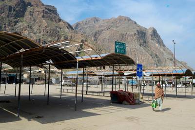 A man walks past at an empty bus terminal near the closed Pakistan-Afghanistan border amid concerns over the spread of the COVID-19 novel coronavirus, in Torkham some 54 kms from Peshahwar.  AFP
