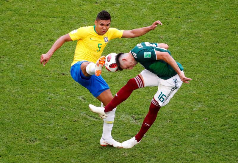 Brazil's Casemiro in action with Mexico's Hector Herrera. David Gray / Reuters