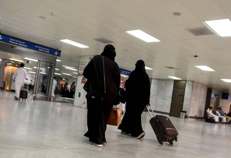 Saudi women roll their suitcases at the departure hall of the Jeddah Airport on August 6, 2019.  Saudi Arabia's easing of travel restrictions on women was hailed in the kingdom last week as a historic leap for gender equality, but it also drew anger from hardliners backing contentious male "guardianship" rules. The Muslim kingdom announced it was effectively allowing women over the age of 21 to obtain passports and travel abroad without securing the permission of their "guardians" -- husband, father or other male relatives.



 / AFP / -
