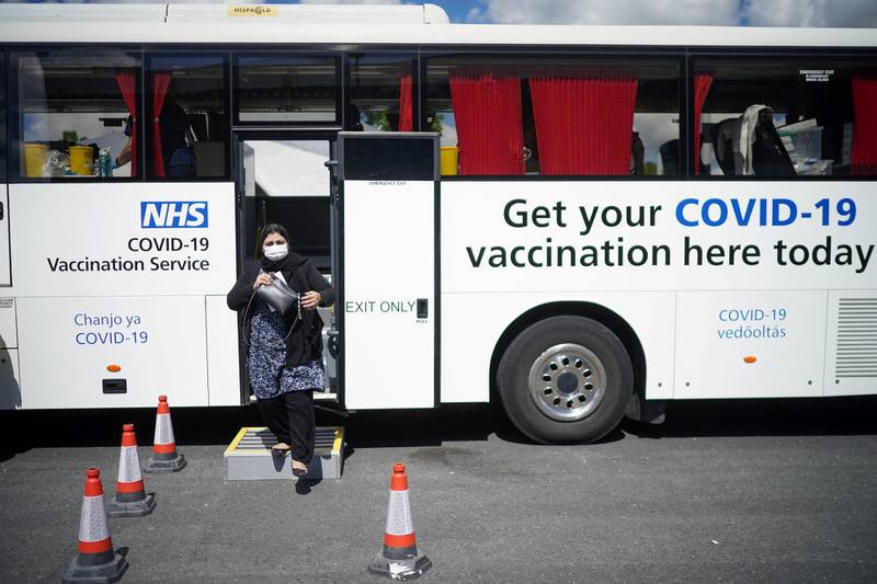 BOLTON, ENGLAND - MAY 18: People leave a mobile vaccination bus after receiving their Covid-19 vaccines at the ESSA academy in Bolton where mass vaccinations are taking place to try and combat rising levels of the Indian coronavirus variant on May 18, 2021 in Bolton, England. Bolton joined the rest of England in resuming indoor dining yesterday, although the UK health secretary has warned that the government will consider a local lockdown in Bolton "if it's necessary to protect people," as the town faces a sharp spike in Covid-19 cases since mid-April. The majority of new cases here involve the more transmissible B.1.617.2 virus variant first identified in India. (Photo by Christopher Furlong/Getty Images)